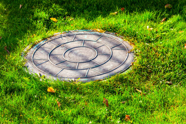 Sewer manhole on a green lawn.